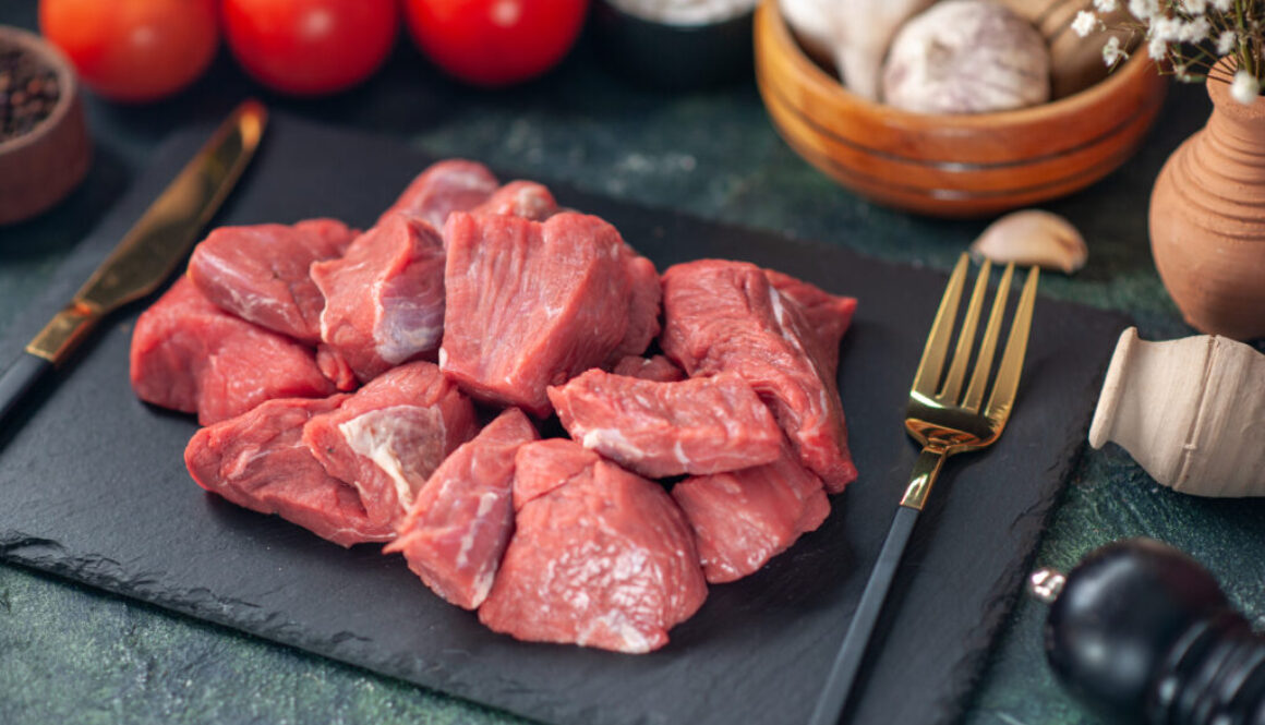 front-close-view-fresh-raw-chopped-meats-cutlery-set-wooden-board